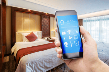 a-hand-holding-a-phone-in-front-of-a-hotel-room